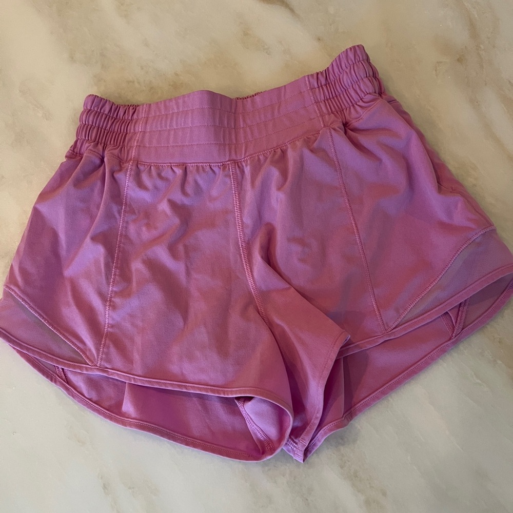 lululemon pink hotty hot shorts. 4” length. Color is possibly magenta glow